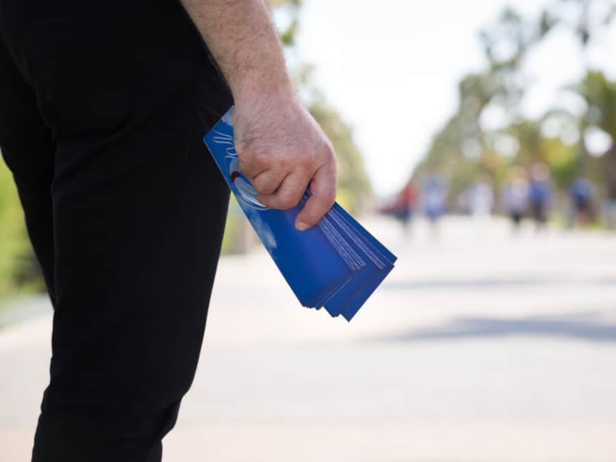 Person Holding Flyers