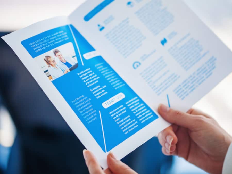 Man Reading Printed Brochure